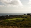 The par-3 sixth hole at The New Links at Bodega Harbour plays over a valley to a shallow, two-tiered green. 